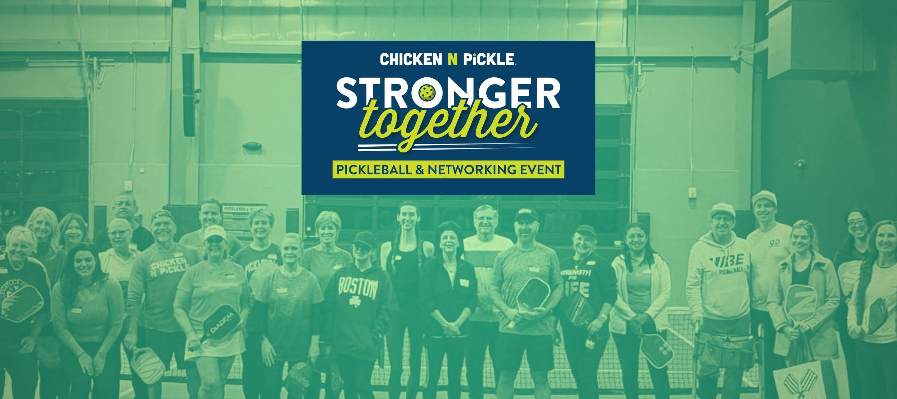 A group of pickleball enthusiasts, including PEP Pickleball representatives, standing together on an indoor pickleball court, holding paddles and smiling during the Stronger Together event at Chicken N Pickle - Grapevine.